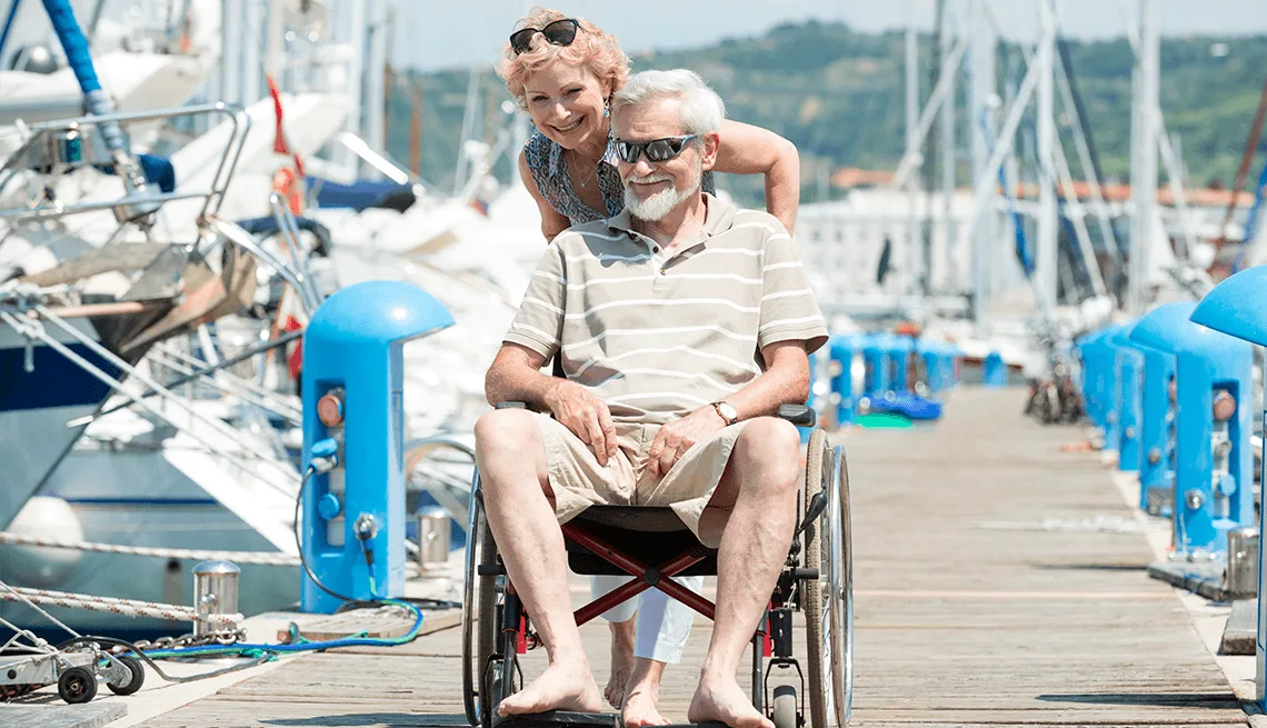 Companion assisting a wheelchair user along a Corfu yacht marina