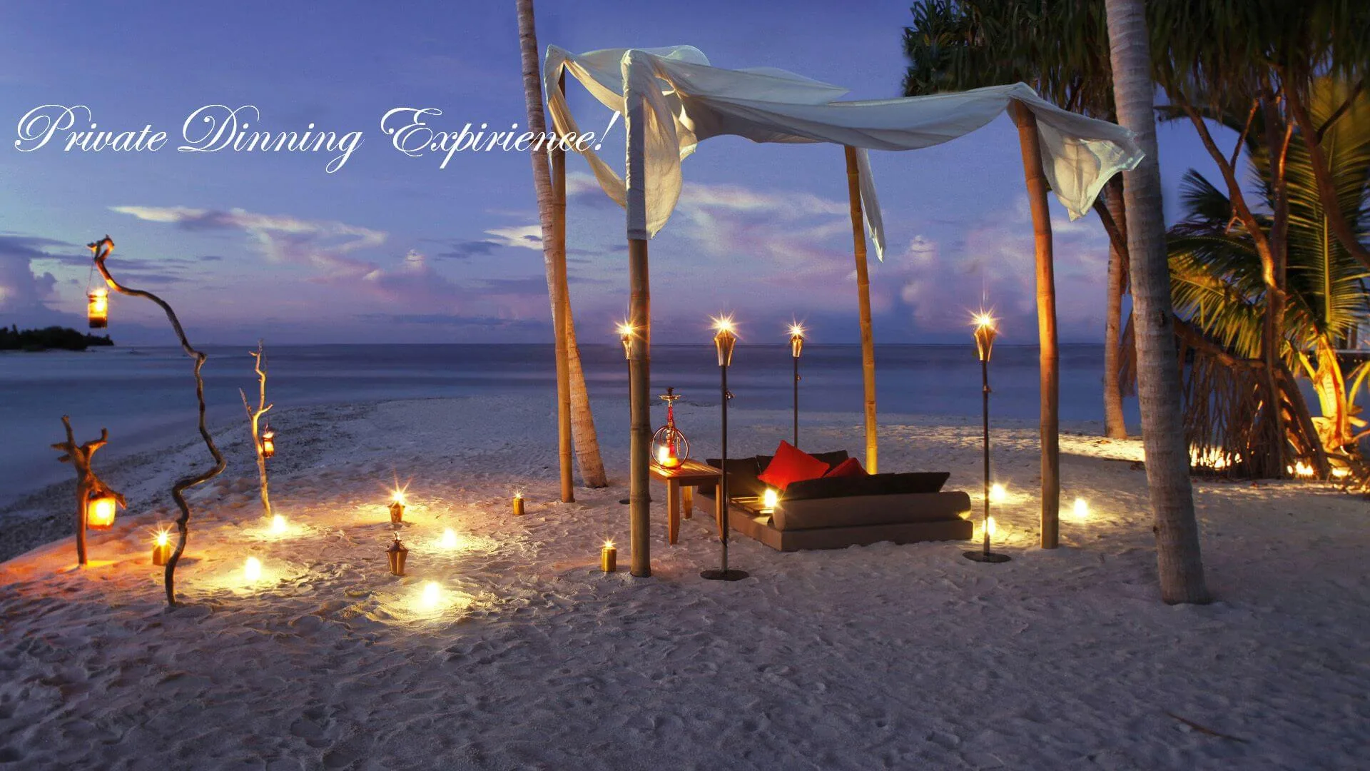 Private sunset dinner on a Corfu beach with lanterns and canopied seating