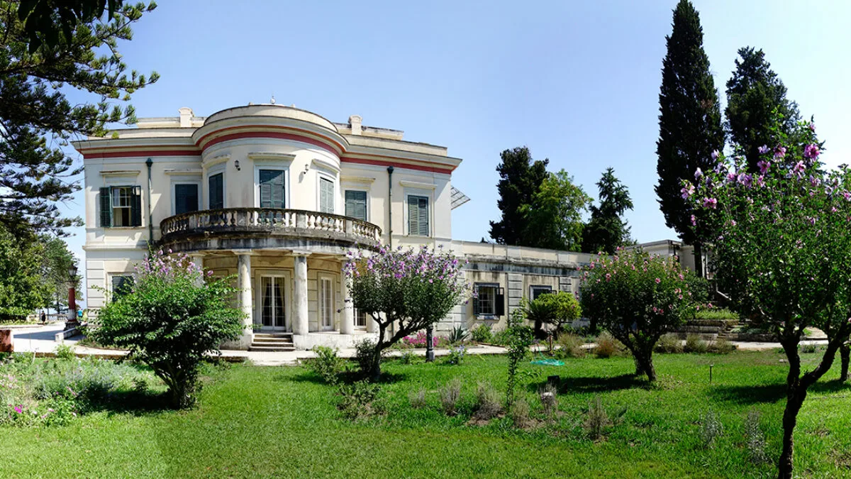 Neoclassical façade of Mon Repo Palace surrounded by gardens, Corfu